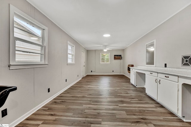 laundry room with crown molding, ceiling fan, and light wood-type flooring