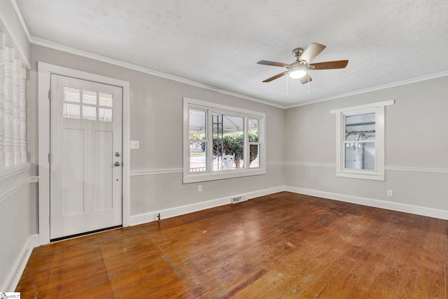 entrance foyer featuring hardwood / wood-style flooring, crown molding, a textured ceiling, and ceiling fan