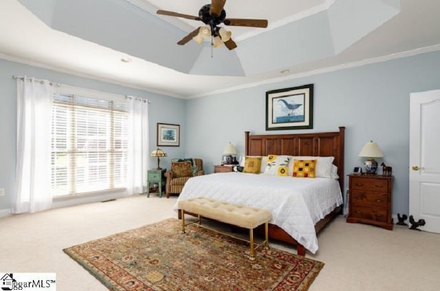 bedroom featuring light carpet, crown molding, a raised ceiling, and ceiling fan