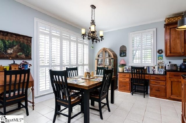 dining area with a notable chandelier, ornamental molding, and light tile patterned flooring