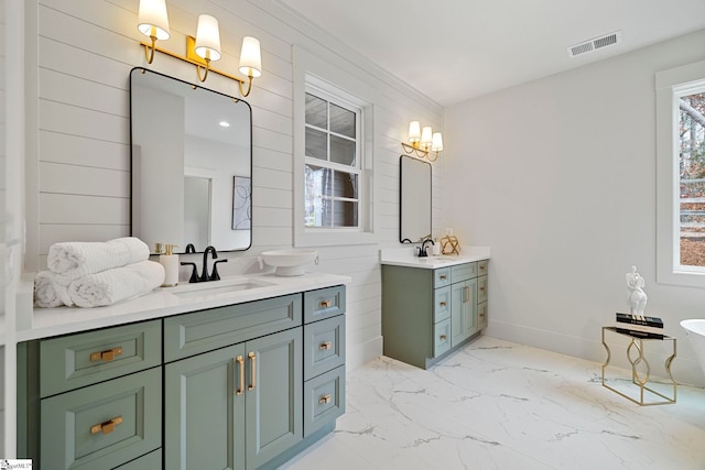 bathroom with vanity, a bath, and wood walls