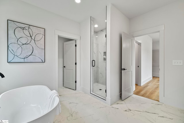 bathroom featuring shower with separate bathtub