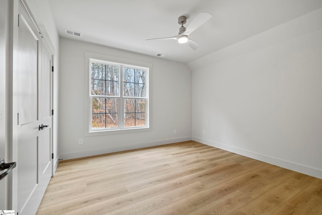 unfurnished bedroom featuring ceiling fan, lofted ceiling, and light wood-type flooring