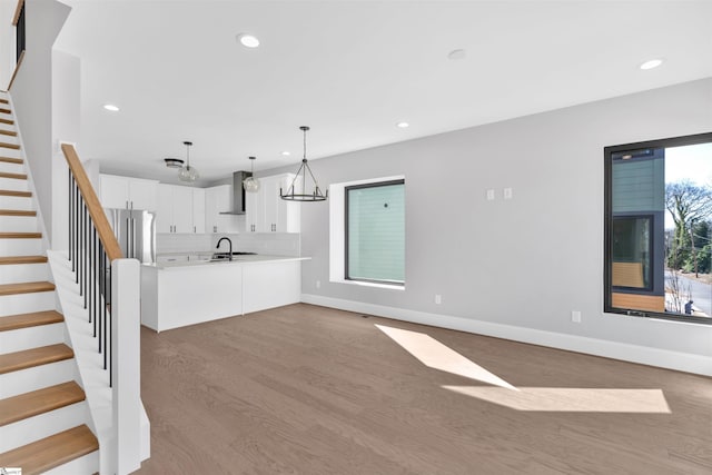 unfurnished living room with plenty of natural light and light wood-type flooring