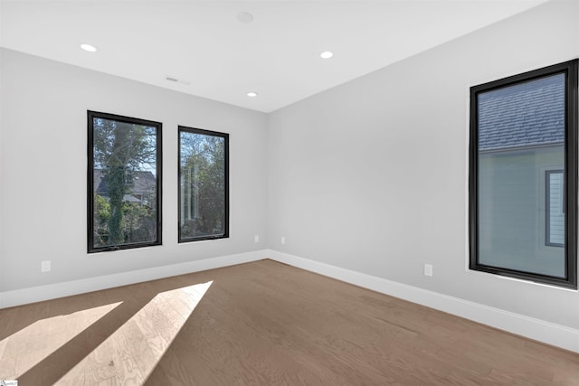 spare room with hardwood / wood-style floors