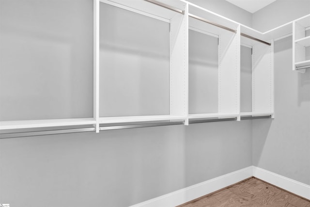 walk in closet with hardwood / wood-style floors