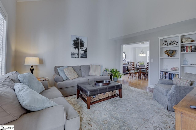 living room with a notable chandelier and light hardwood / wood-style flooring