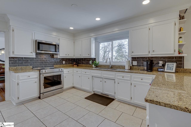 kitchen featuring light stone counters, sink, white cabinets, and appliances with stainless steel finishes