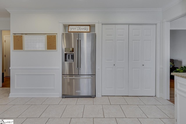 kitchen with light tile patterned flooring, high quality fridge, and crown molding