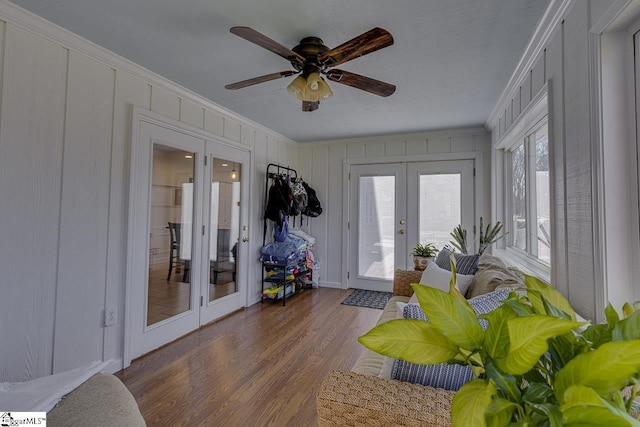 interior space with french doors, ceiling fan, crown molding, and dark wood-type flooring