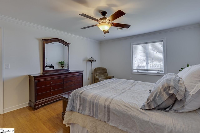 bedroom with ceiling fan, ornamental molding, and light hardwood / wood-style floors