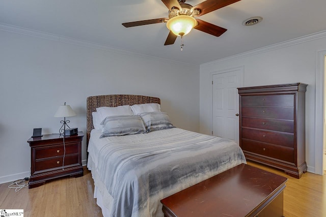 bedroom with crown molding, ceiling fan, and light hardwood / wood-style flooring