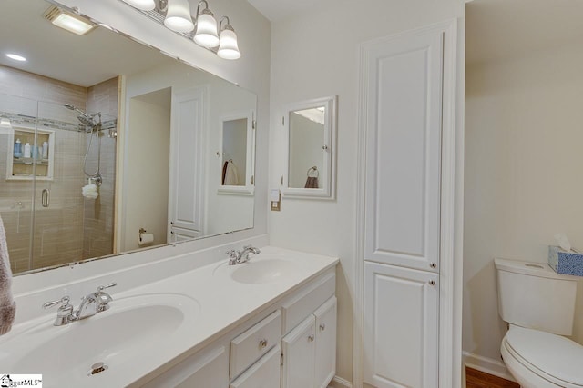 bathroom featuring walk in shower, vanity, and toilet