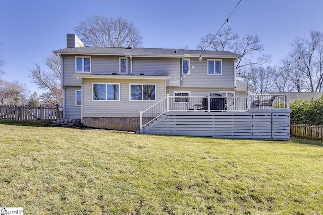 back of house with a deck and a lawn