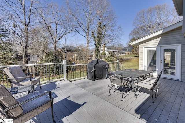 wooden deck with a grill