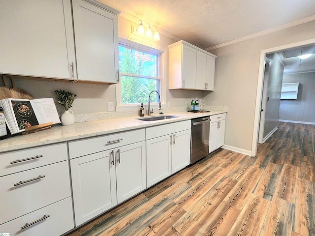 kitchen with sink, white cabinetry, wood-type flooring, ornamental molding, and dishwasher