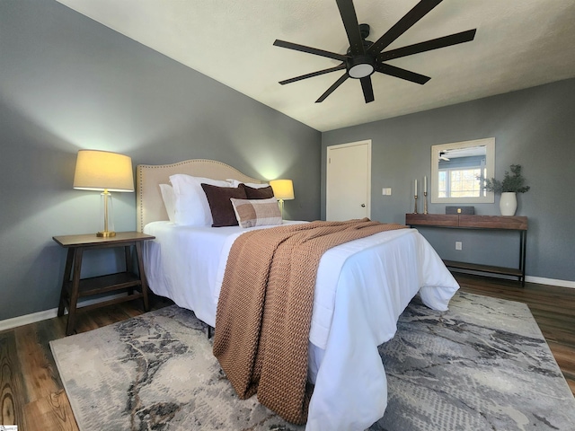 bedroom featuring dark hardwood / wood-style floors and ceiling fan