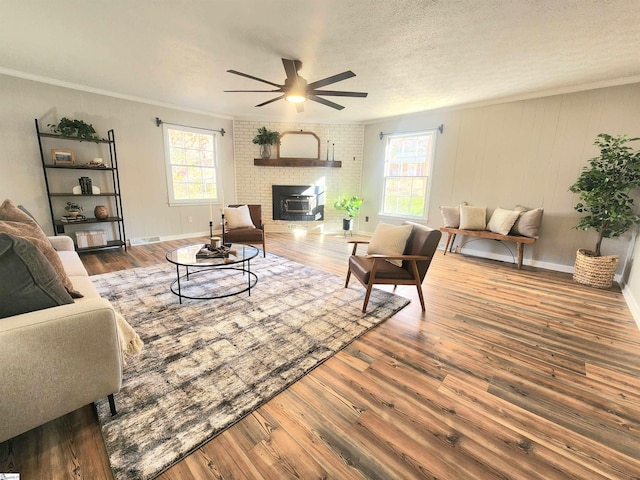 living room with hardwood / wood-style floors, plenty of natural light, a textured ceiling, and ceiling fan