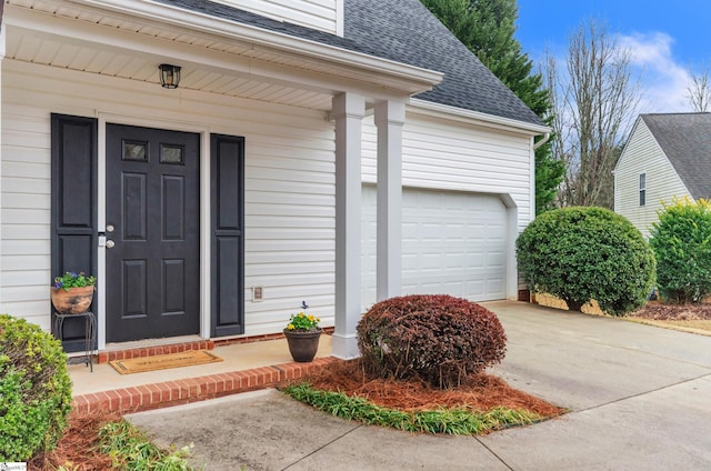 entrance to property featuring a garage and a porch