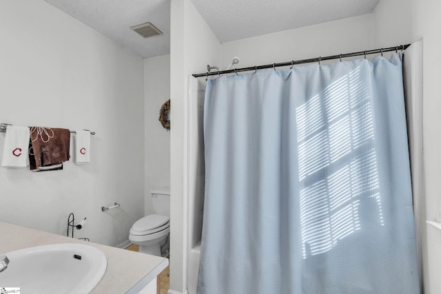 full bathroom with vanity, toilet, shower / bath combination with curtain, and a textured ceiling