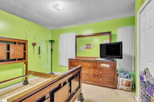 carpeted bedroom with a textured ceiling