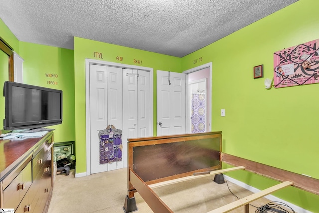 bedroom with light colored carpet, a closet, and a textured ceiling