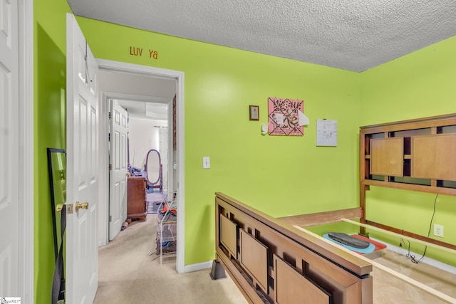 carpeted bedroom featuring a textured ceiling