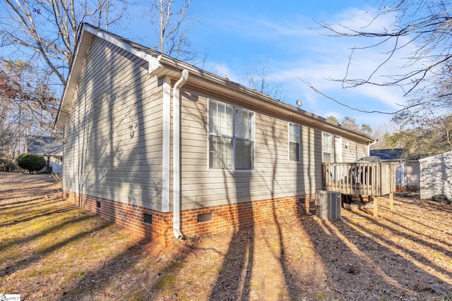 view of property exterior featuring central AC unit and a deck