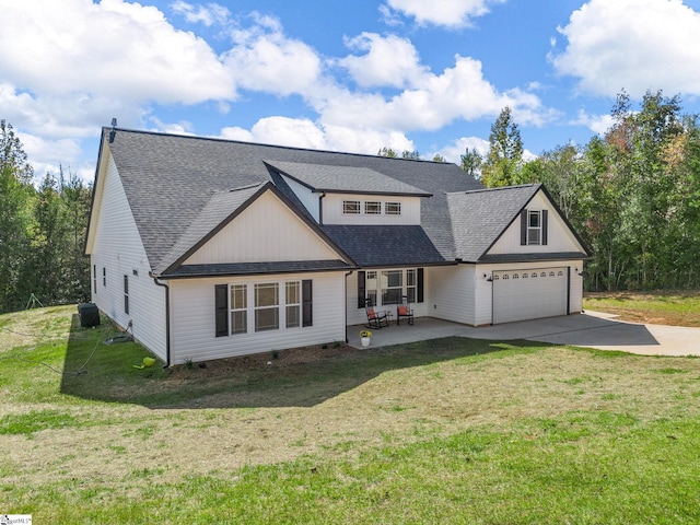 view of front of home featuring a patio, a front yard, and a garage