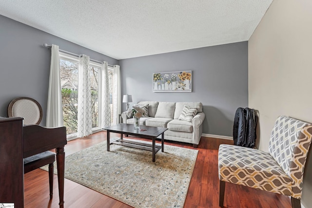 living room with dark hardwood / wood-style flooring and a textured ceiling