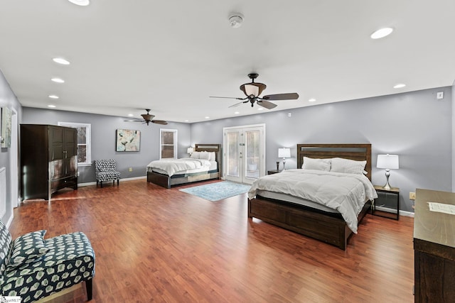 bedroom featuring access to exterior, hardwood / wood-style floors, and ceiling fan