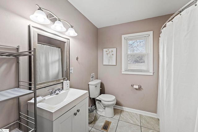 bathroom with tile patterned floors, vanity, and toilet