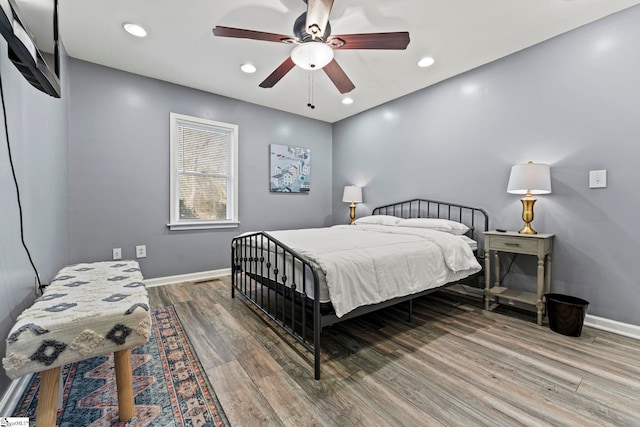 bedroom with hardwood / wood-style floors and ceiling fan