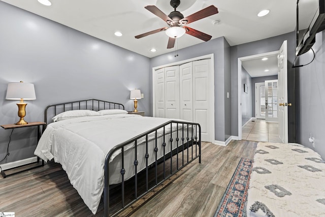 bedroom featuring ceiling fan, wood-type flooring, and a closet