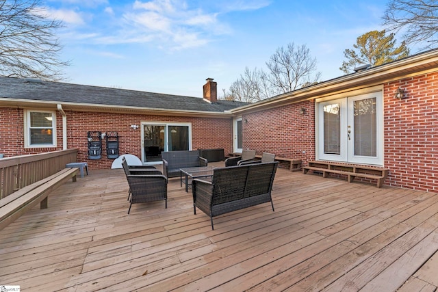 wooden deck featuring french doors and an outdoor living space