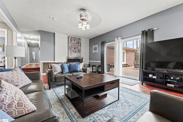 living room with hardwood / wood-style floors and a textured ceiling