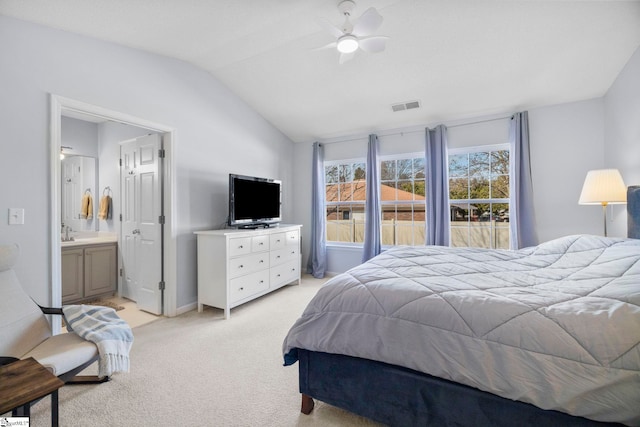 carpeted bedroom featuring lofted ceiling, sink, connected bathroom, and ceiling fan