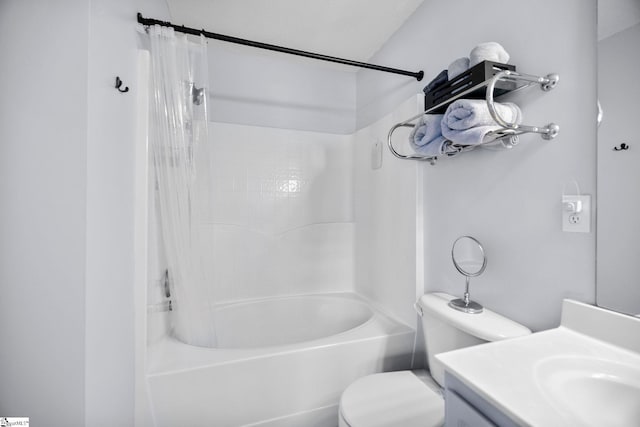 full bathroom with vanity, shower / tub combo with curtain, and toilet