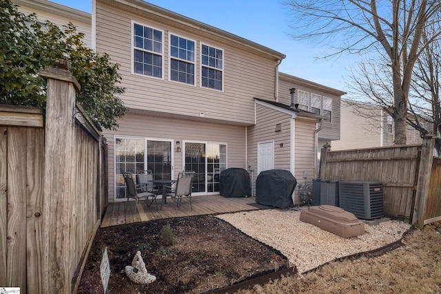 back of house featuring cooling unit and a deck