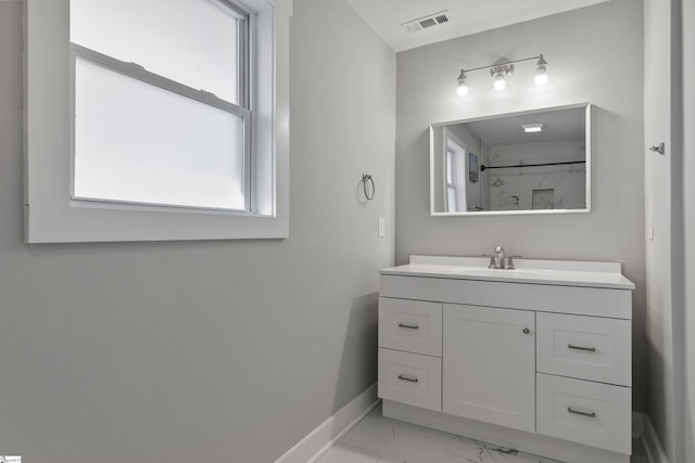 bathroom featuring vanity and a shower