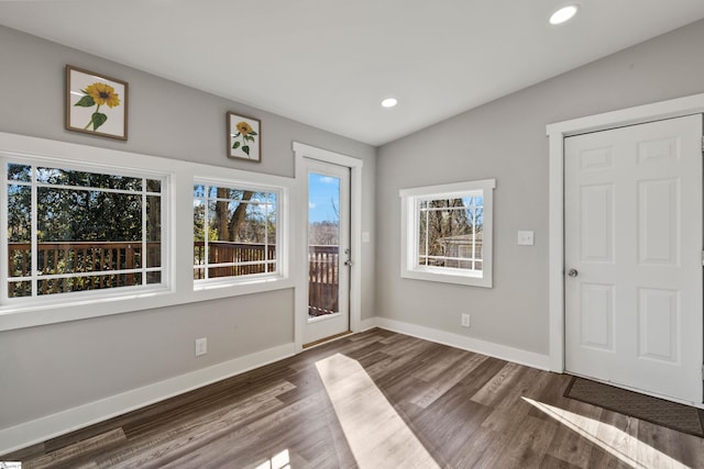 entrance foyer with vaulted ceiling and dark wood-type flooring