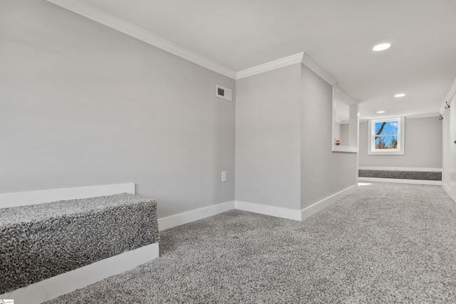 hallway with ornamental molding and carpet