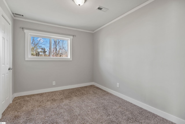 unfurnished room with crown molding and carpet