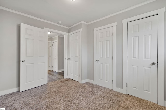 unfurnished bedroom with ornamental molding and dark carpet