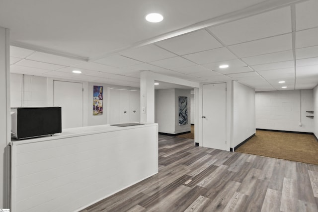 basement with hardwood / wood-style flooring and a drop ceiling