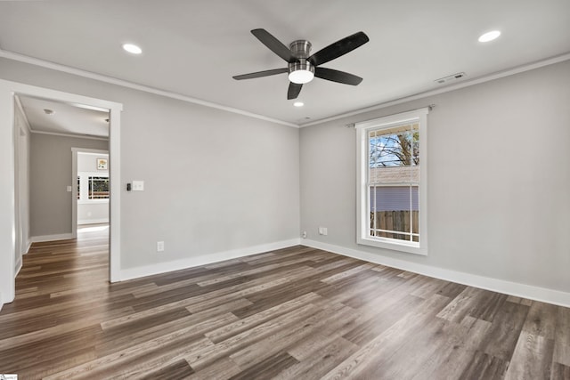 spare room featuring crown molding, ceiling fan, and dark hardwood / wood-style flooring