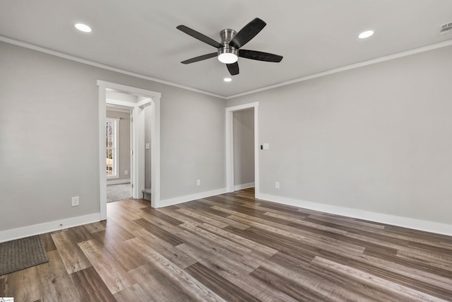 unfurnished room with dark hardwood / wood-style flooring, ornamental molding, and ceiling fan