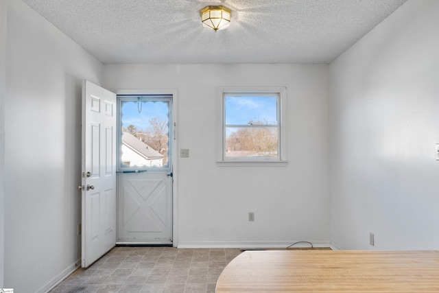 foyer with a textured ceiling