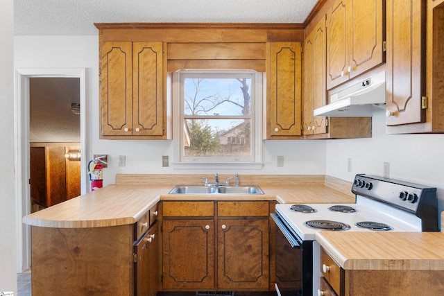 kitchen featuring electric range oven, sink, a textured ceiling, and kitchen peninsula