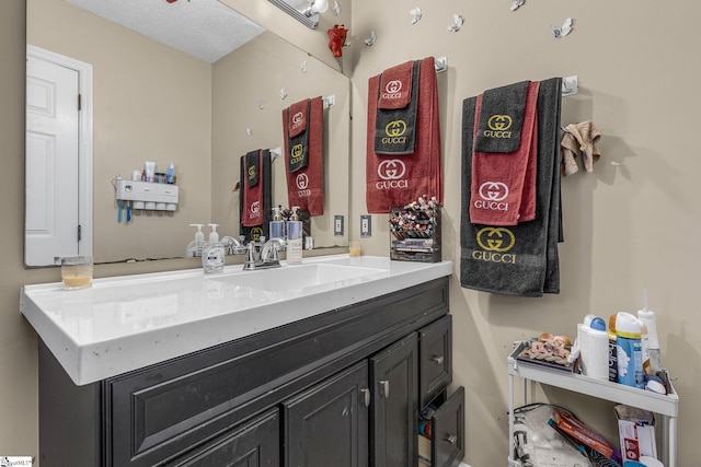 bathroom with vanity and a textured ceiling